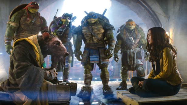Left to right: Raphael, Splinter, Donatello, Leonardo, Michelangelo, and Megan Fox as April O'Neil in TEENAGE MUTANT NINJA TURTLES, from Paramount Pictures and Nickelodeon Movies.